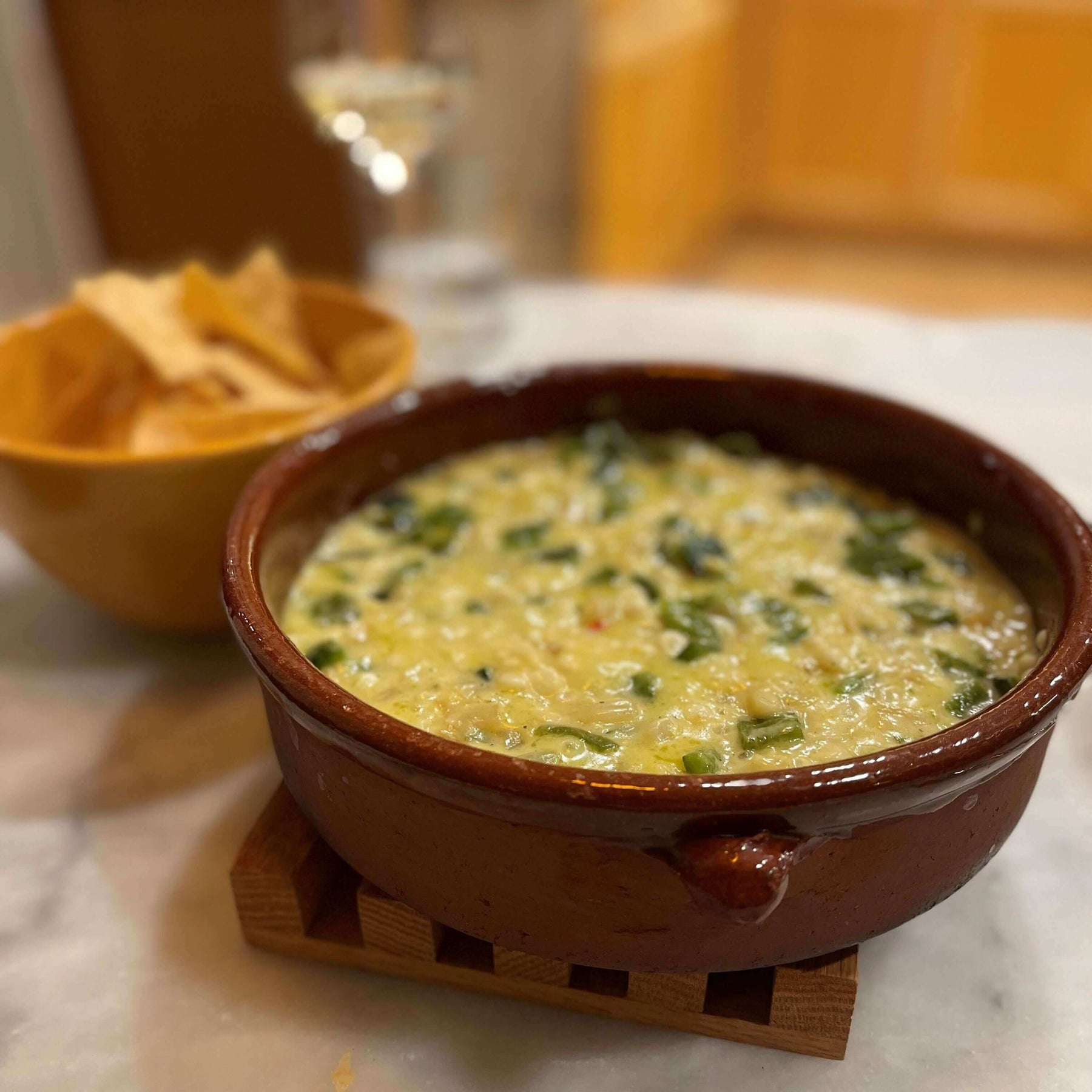 Delicious Chile And Cheese Recipe served in a traditional dish with tortilla chips on the side.