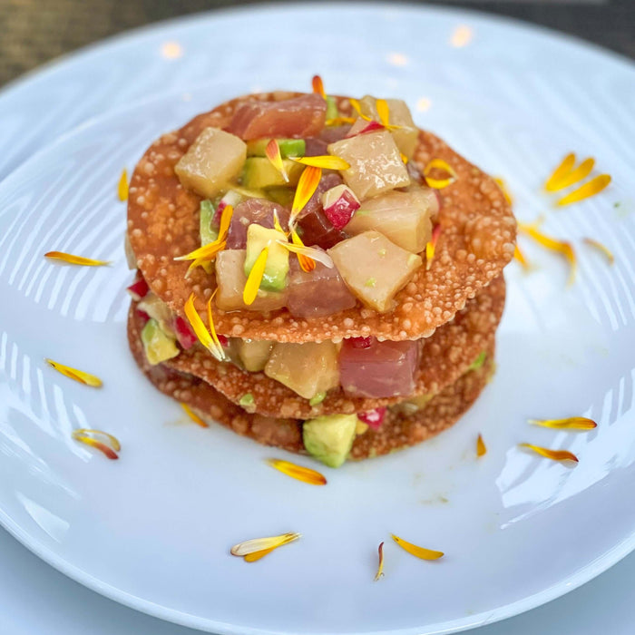 Ahi/Hamachi Napoleon Recipe served in a delightful presentation with colorful toppings.