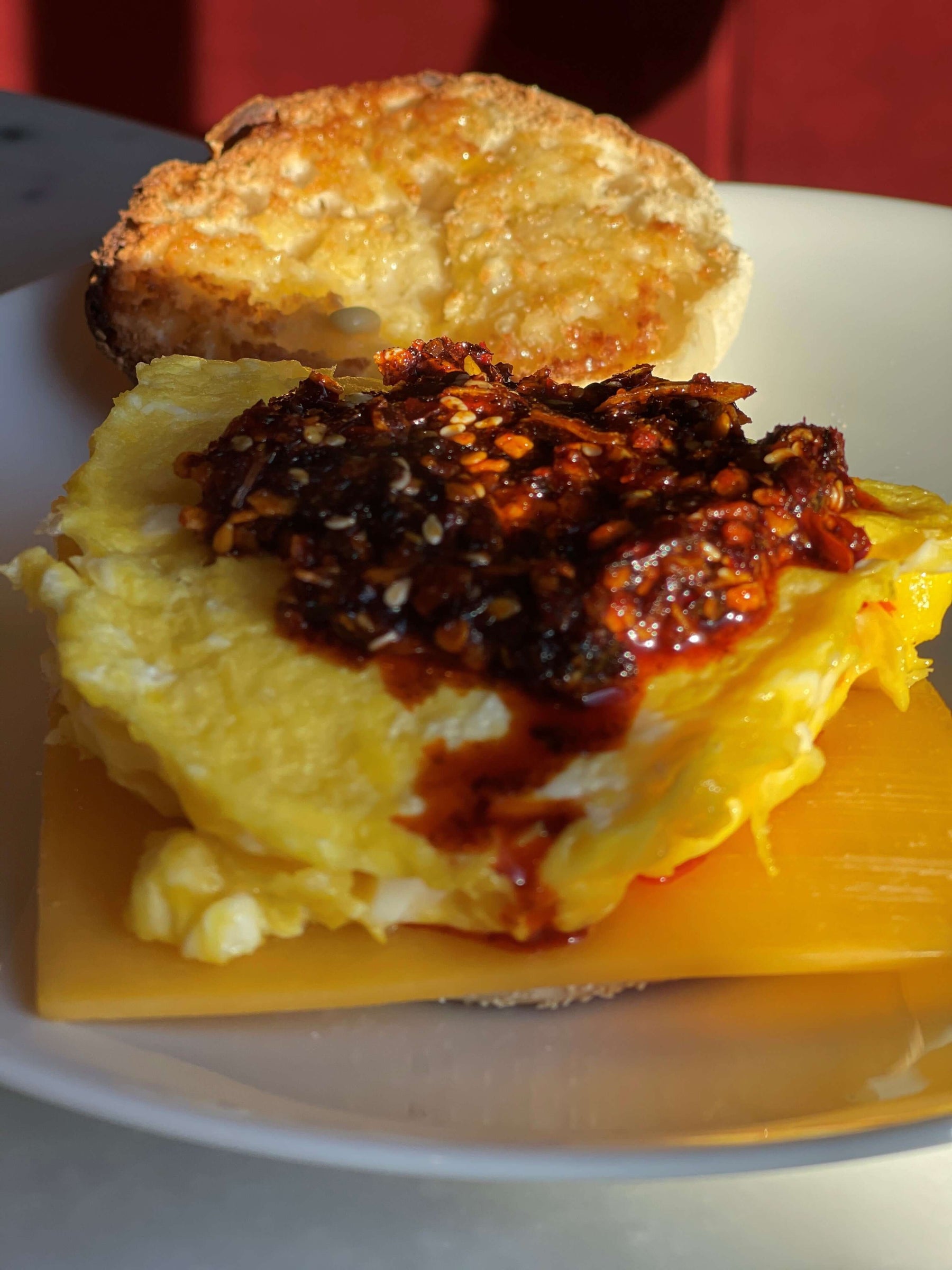 Recipe: Chile Crunch - ala Walt featuring a delicious omelette topped with chile crunch on a toasted bun.