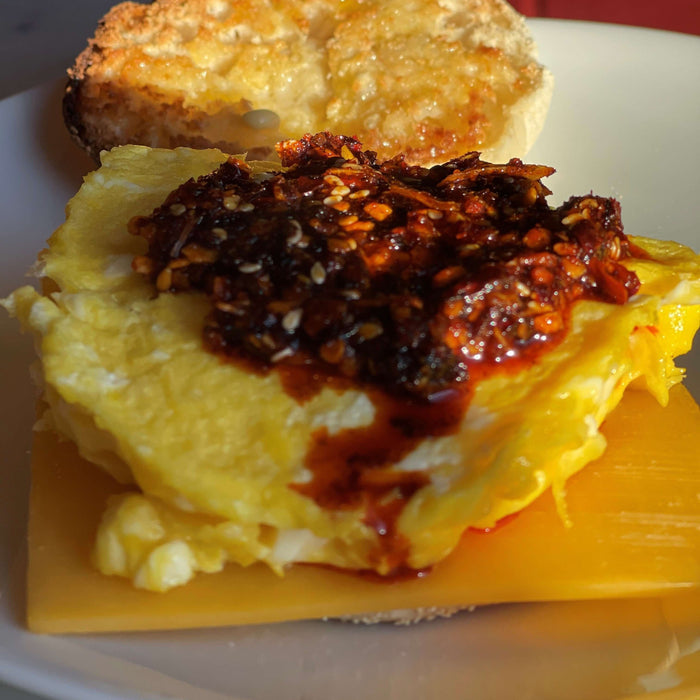 Recipe: Chile Crunch - ala Walt featuring a delicious omelette topped with chile crunch on a toasted bun.