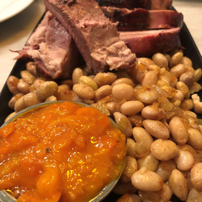 Pork, Beans and Tomato Jam Recipe featuring tender pork, beans, and a vibrant tomato jam on a platter.