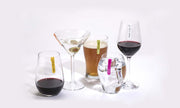 Colorful mini silicone identifiers on various stemless glasses filled with drinks.