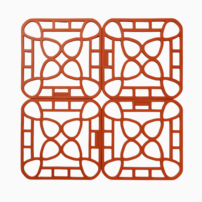 Interlocking silicone trivet in orange, featuring a unique modular design for heat-resistant protection.