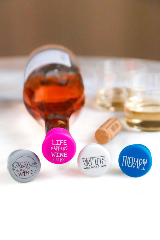 Colorful silicone wine caps from Therapy Silicone Wine Cap Set by CapaBunga, sealing wine bottles with fun phrases.