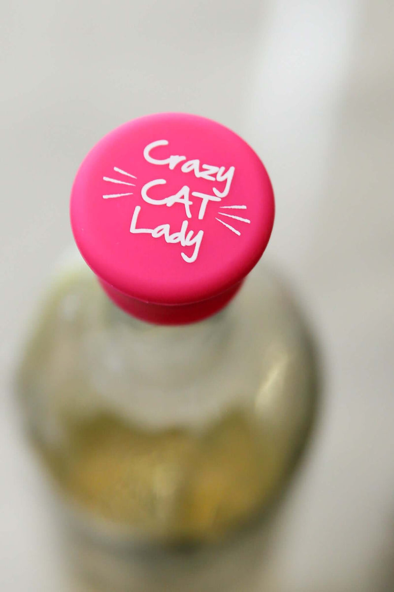 Crazy Cat Lady silicone wine cap in vibrant pink on a glass bottle, perfect for cat lovers.