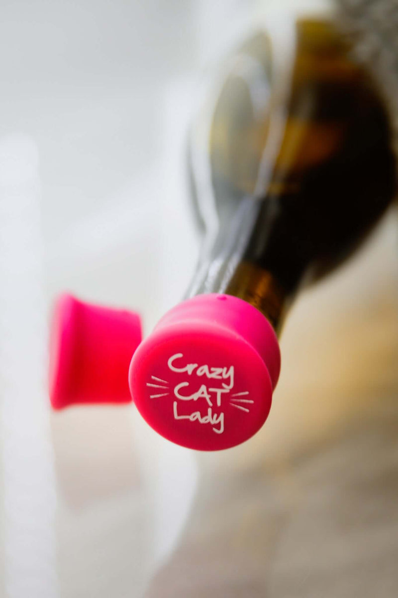 Crazy Cat Lady silicone wine cap in bright pink on a wine bottle, perfect for cat lovers who enjoy wine.