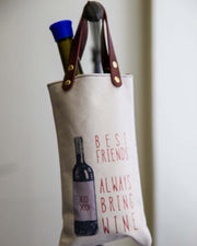 Canvas wine tote with 'Best Friends Always Bring Wine' design, featuring sturdy vegan leather handles.