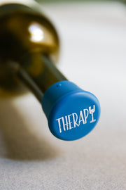 Therapy Silicone Wine Cap on a wine bottle, adding a fun twist to wine storage.