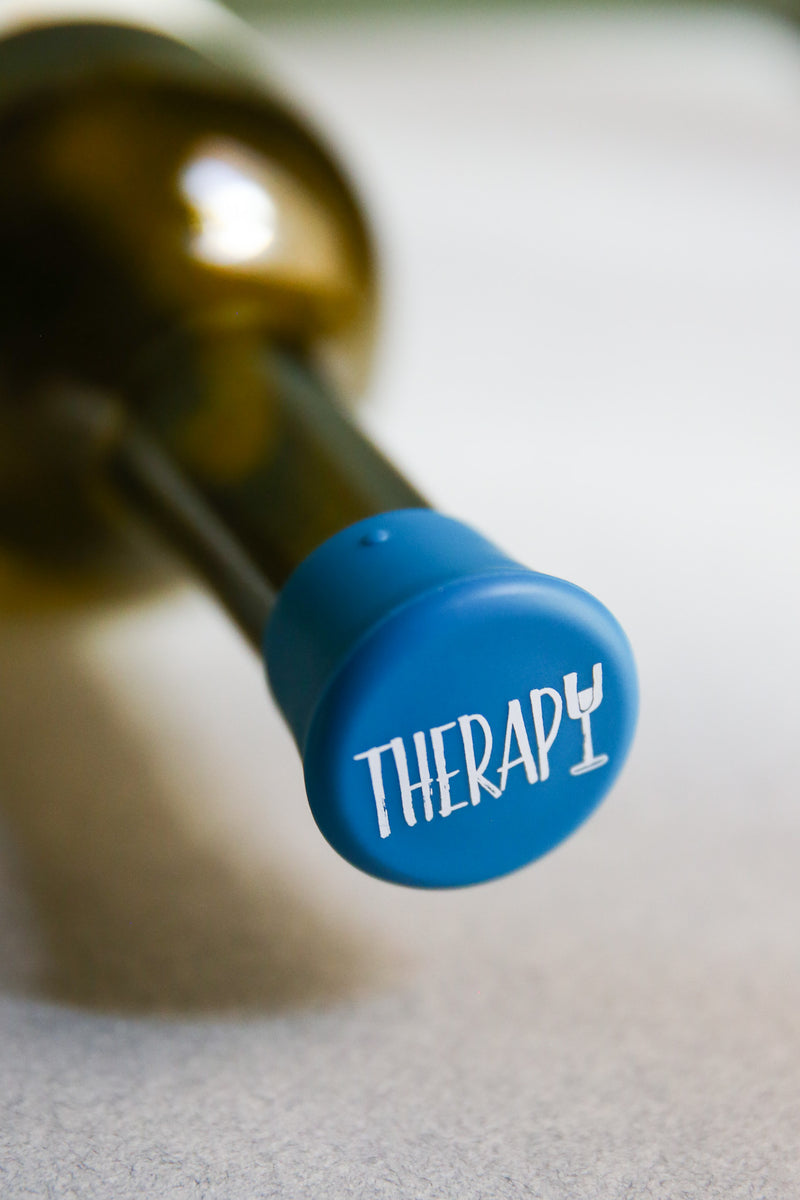 Therapy Silicone Wine Cap on a wine bottle, adding a fun twist to wine storage.
