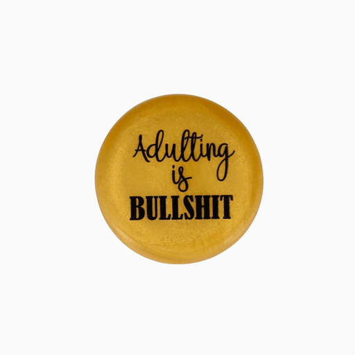 Yellow silicone wine cap with the phrase 'Adulting is BULLSHIT' designed for fun and humor.