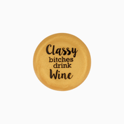 Gold silicone wine cap with the text 'Classy bitches drink wine' designed for stylish wine enthusiasts.