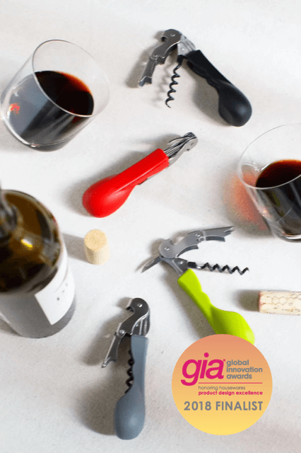 Silicone handled corkscrews by CapaBunga in red, black, and green with wine glasses and a bottle.