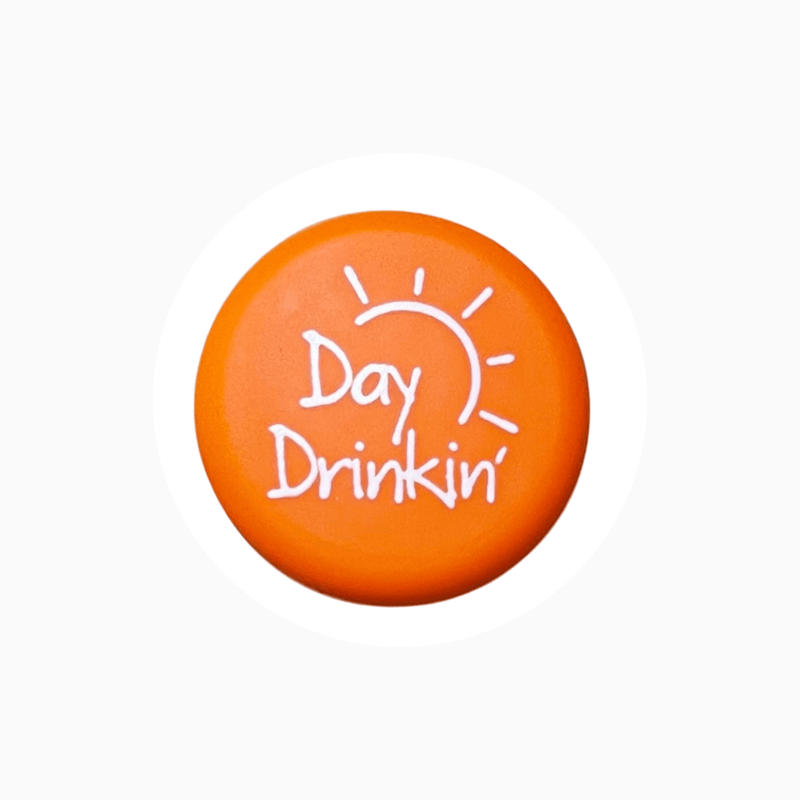 Orange silicone wine cap with text "Day Drinkin'" and sun graphic design.