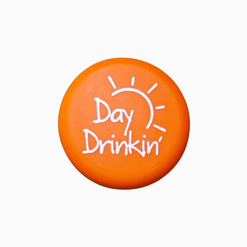Orange silicone wine cap with the text 'Day Drinkin'' and a sun design, perfect for casual wine lovers.