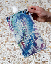 Colorful Day Tripper canvas canteen holding a bottle, perfect for stylish outdoor adventures.