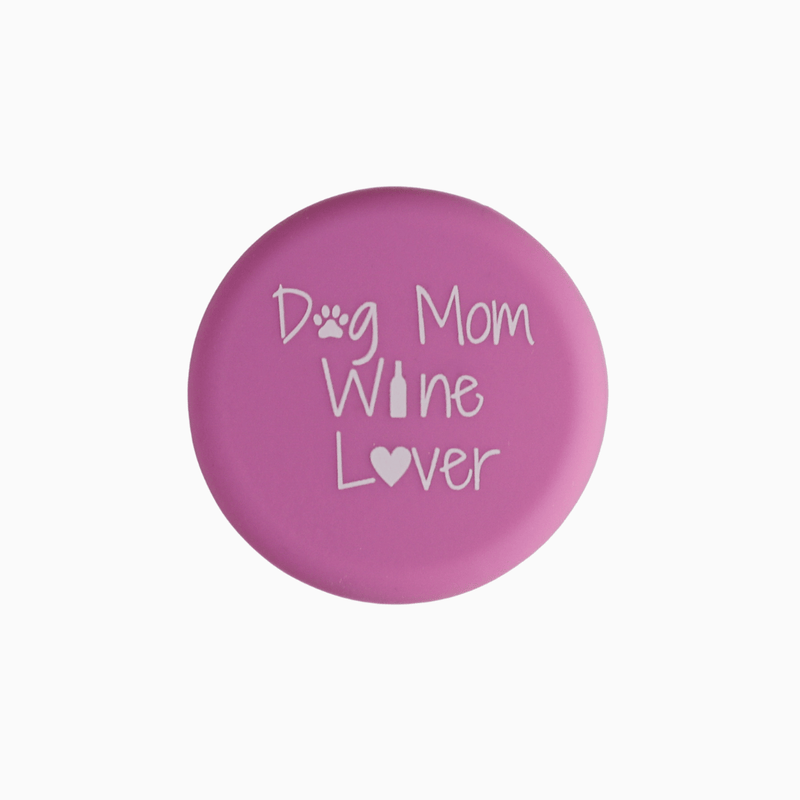 Pink silicone wine cap with text 'Dog Mom Wine Lover' featuring paw print and heart design.