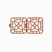 Interlocking silicone trivet featuring a unique modular design and heat-resistant properties, shown in vibrant orange color.