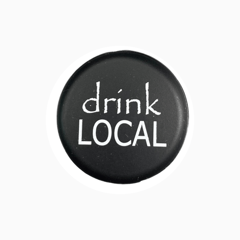 Black silicone wine cap with the phrase 'drink LOCAL' designed for wine enthusiasts.
