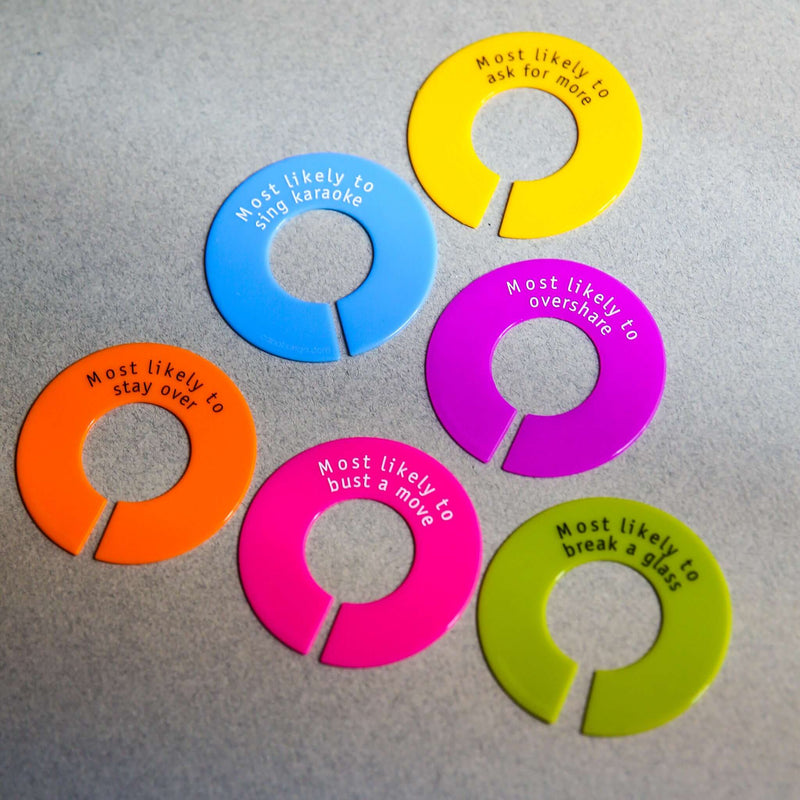 Colorful silicone wine glass identifiers with humorous labels for parties, enhancing fun and preventing glass mix-ups.