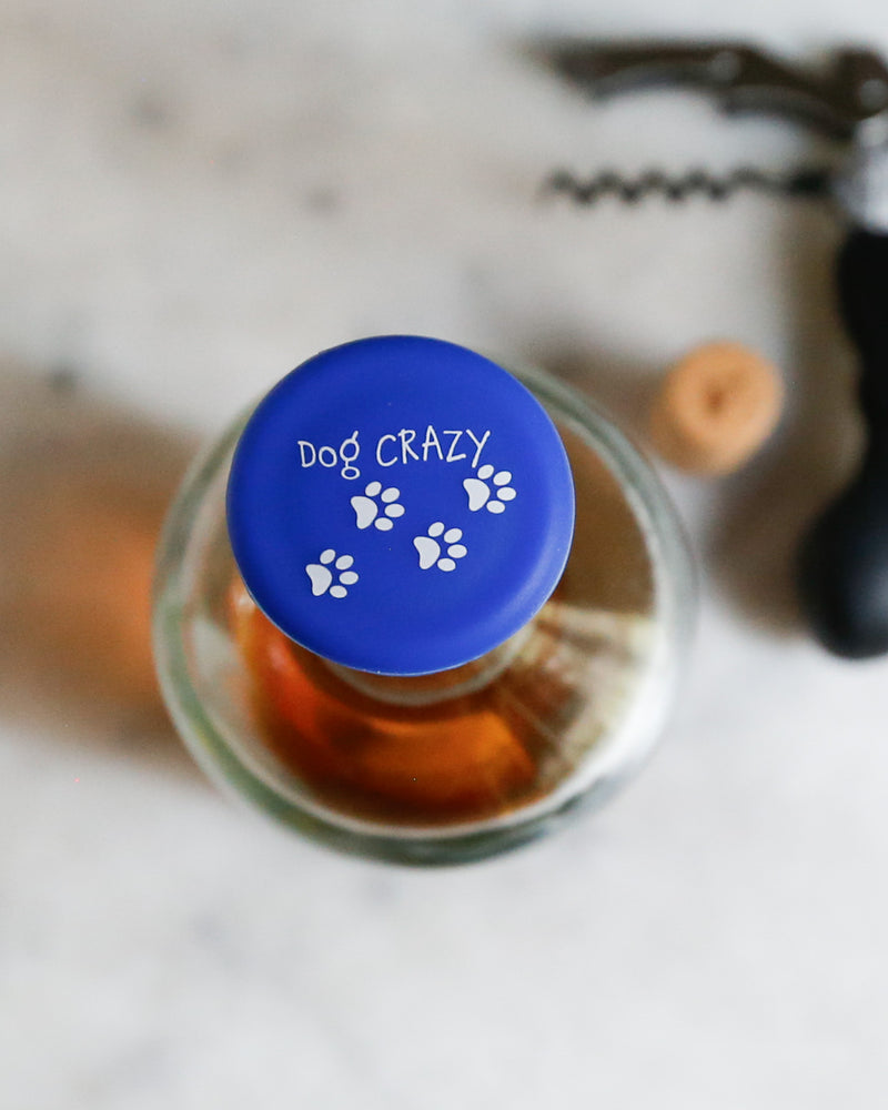 Dog Crazy silicone wine cap with paw print design, perfect for proud dog owners.