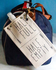 Canvas canteen with 'Half Full' and 'Half Empty' labels on a stylish bag, perfect for carrying beverages.