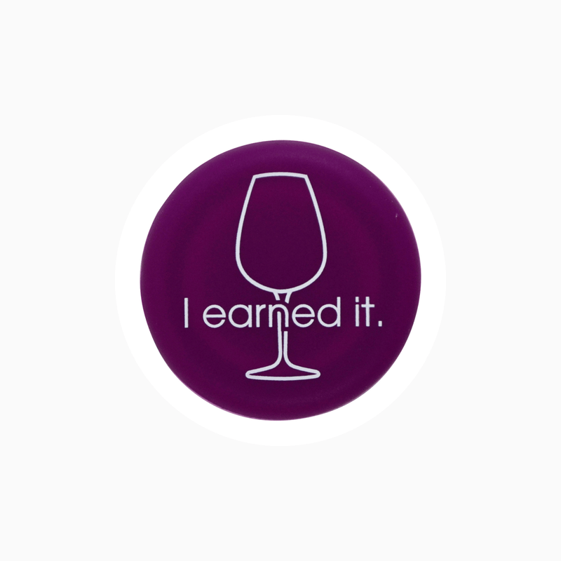 Purple silicone wine cap with the phrase 'I earned it.' featuring a wine glass illustration.