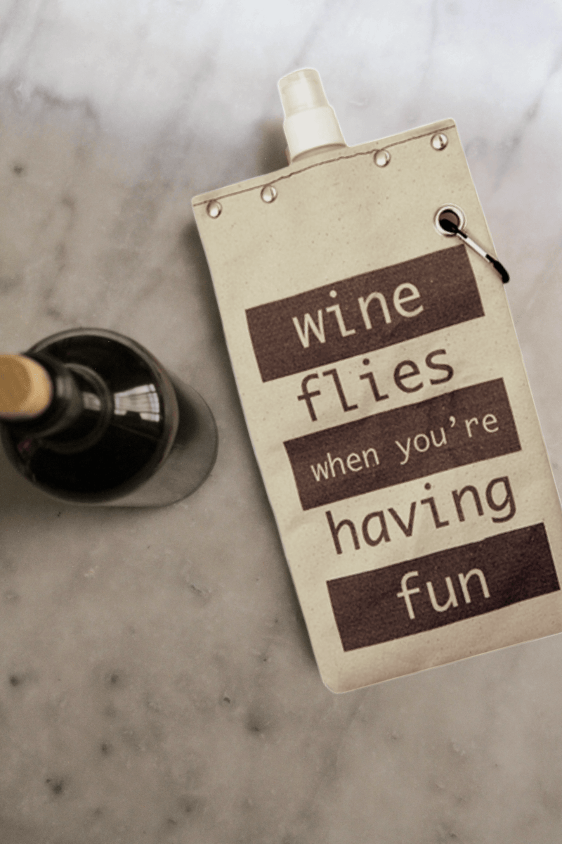 Wine Flies 750ml canvas canteen with fun text design and wine bottle in background, perfect for outdoor adventures.
