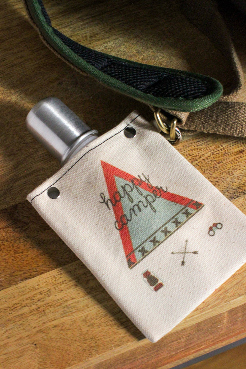 Happy Camper 120ml canvas flask with camping design, featuring a silver bottle and a rugged cotton cover.