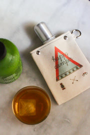 Happy Camper 120ml canvas flask with camping design, featuring a silver bottle and a rugged cotton cover.