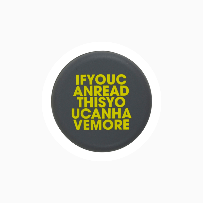 Black silicone wine cap with yellow text saying "IFYOUCANREADTHISYOUCANHAVEMORE".