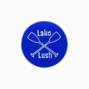 Lake Lush silicone wine cap featuring crossed paddles design in vibrant blue.