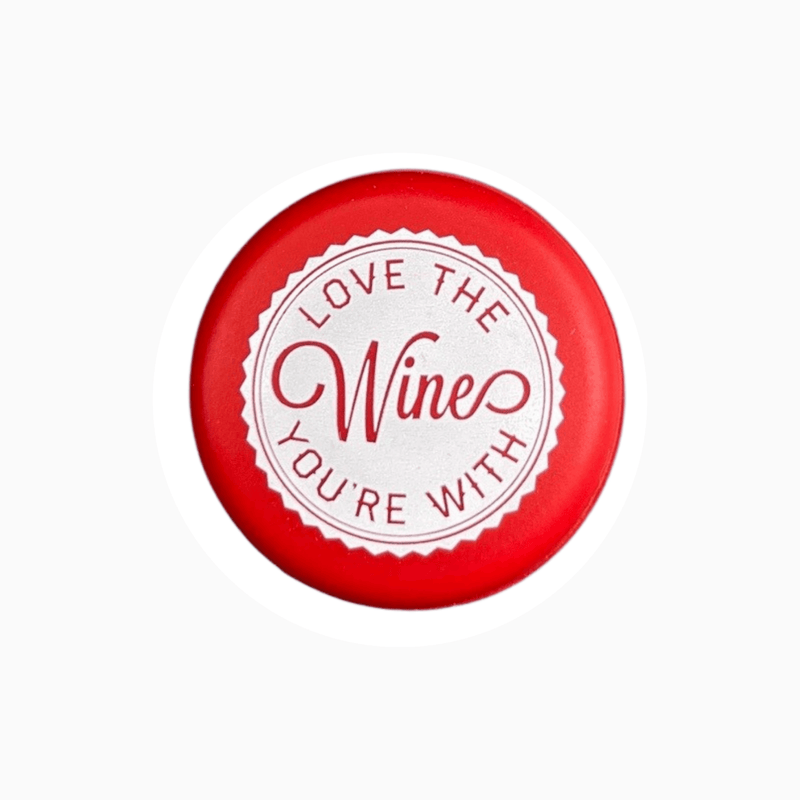 Red silicone wine cap that reads 'Love the wine you're with' in decorative text.
