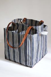 Striped market tote with pockets and leather handles for easy shopping and organization.