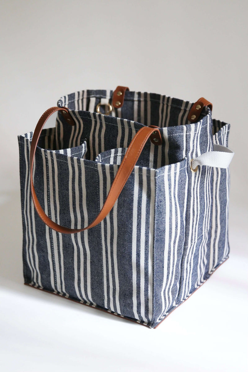 Striped market tote with pockets and leather handles for easy shopping and organization.