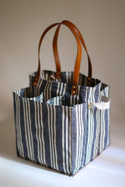 Striped market tote with pockets and leather handles, perfect for shopping and organizing your groceries.
