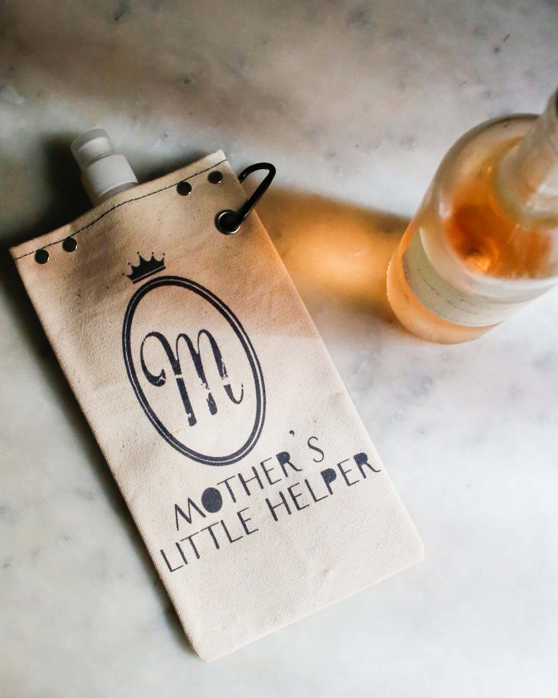 Mother's Helper 750ml canvas canteen with stylish design, next to a bottle of rosé wine on a marble surface.