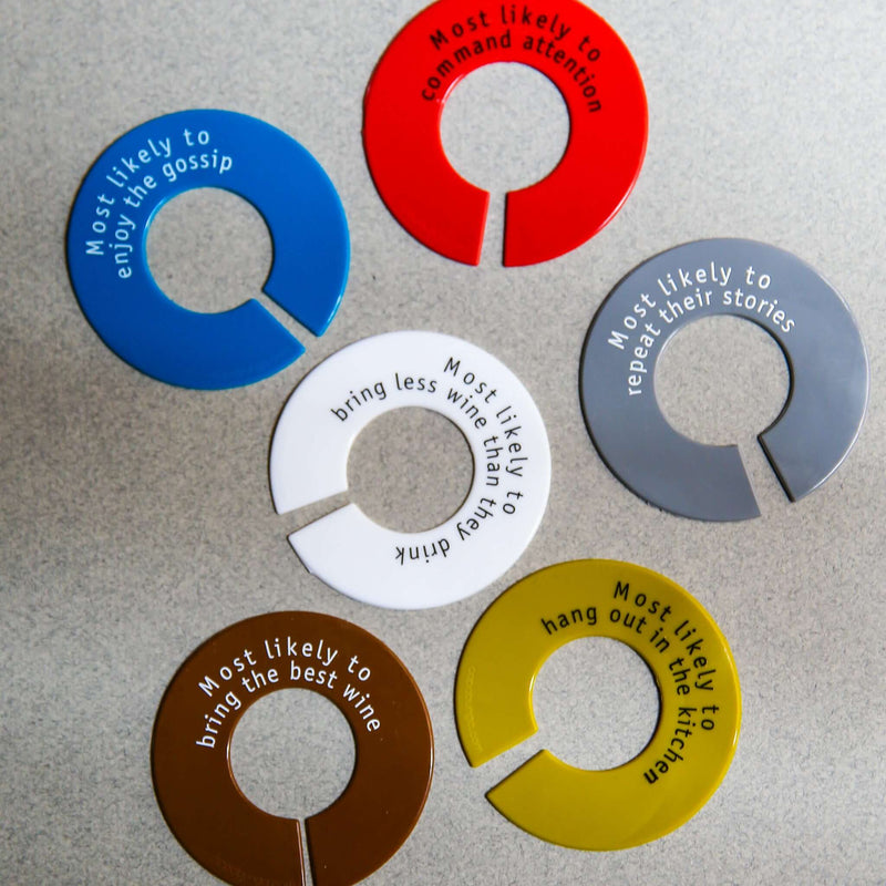 Colorful silicone wine glass identifiers with humorous labels for parties and events.