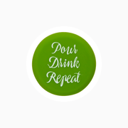 Green silicone wine cap with the text 'Pour Drink Repeat' for wine preservation.