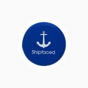 Blue silicone wine cap with anchor design and "Shipfaced" text, ideal for sealing bottles.