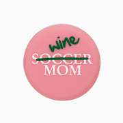 Pink silicone wine cap design featuring 'Soccer Mom' crossed out with 'Wine' written on top.