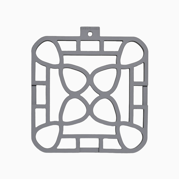 Interlocking silicone trivet in gray color with a unique modular design, providing stylish heat resistance for your table.