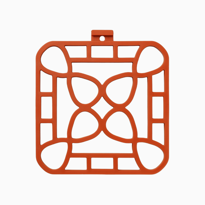 Interlocking silicone trivet in orange color, designed for heat-resistance and stylish serving.