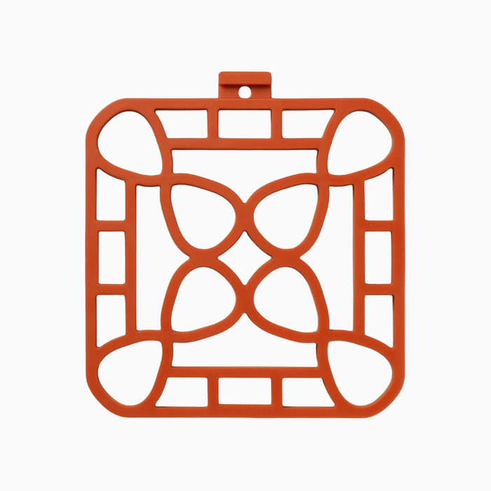 Interlocking silicone trivet in orange color, designed for heat-resistance and stylish serving.