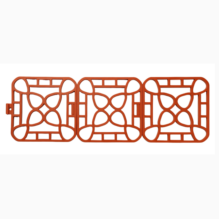 Interlocking silicone trivet in orange color featuring a modular design for heat-resistant protection.