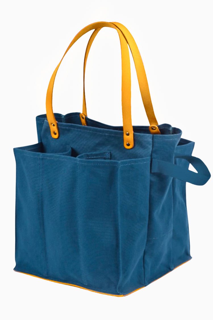 Petrol blue market tote bag with multiple pockets and yellow handles for shopping convenience.