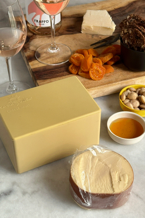 CapaBunga Cheese Vault with cheese and accompaniments on a marble table, perfect for cheese storage and freshness.