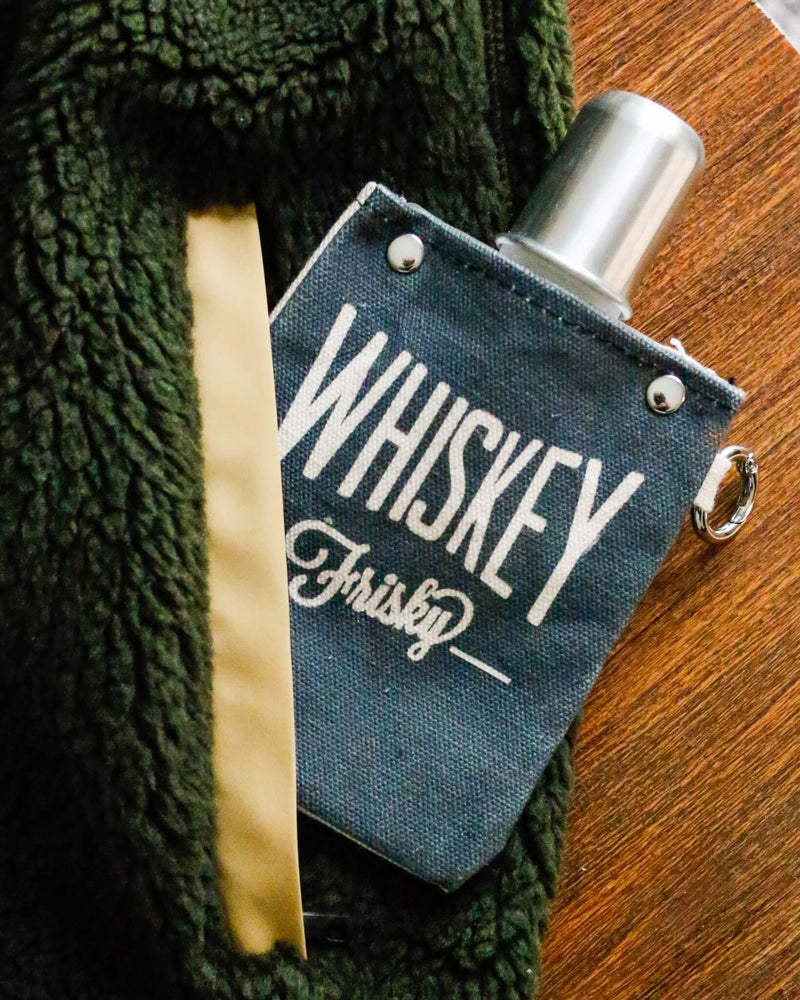 Whiskey Frisky 120ml canvas flask with silver top, featuring bold white lettering on a dark canvas background.