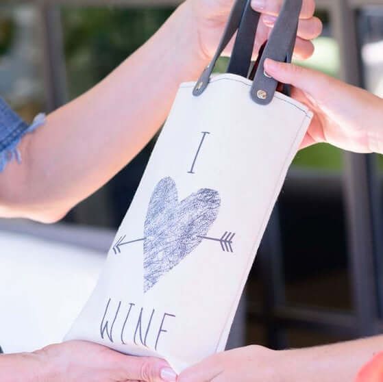 I Heart Wine Design canvas wine tote with vegan leather handles, perfect for gifting and carrying bottles.