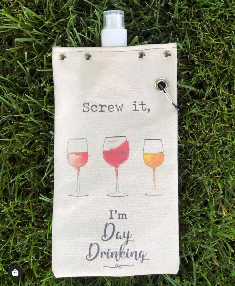 Day Drinking canvas canteen with graphic of wine glasses and text, perfect for carrying beverages.