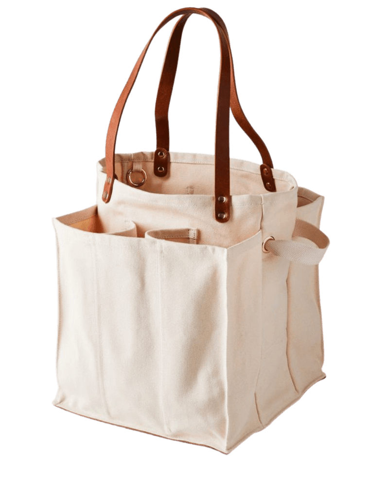 Natural multi-pocket canvas market tote with brown leather handles, ideal for organized shopping and carrying groceries.